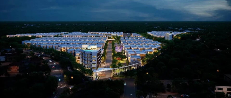 Aerial view of Casagrand Vybe at night with the arrival court and clubhouse lit, artist impression